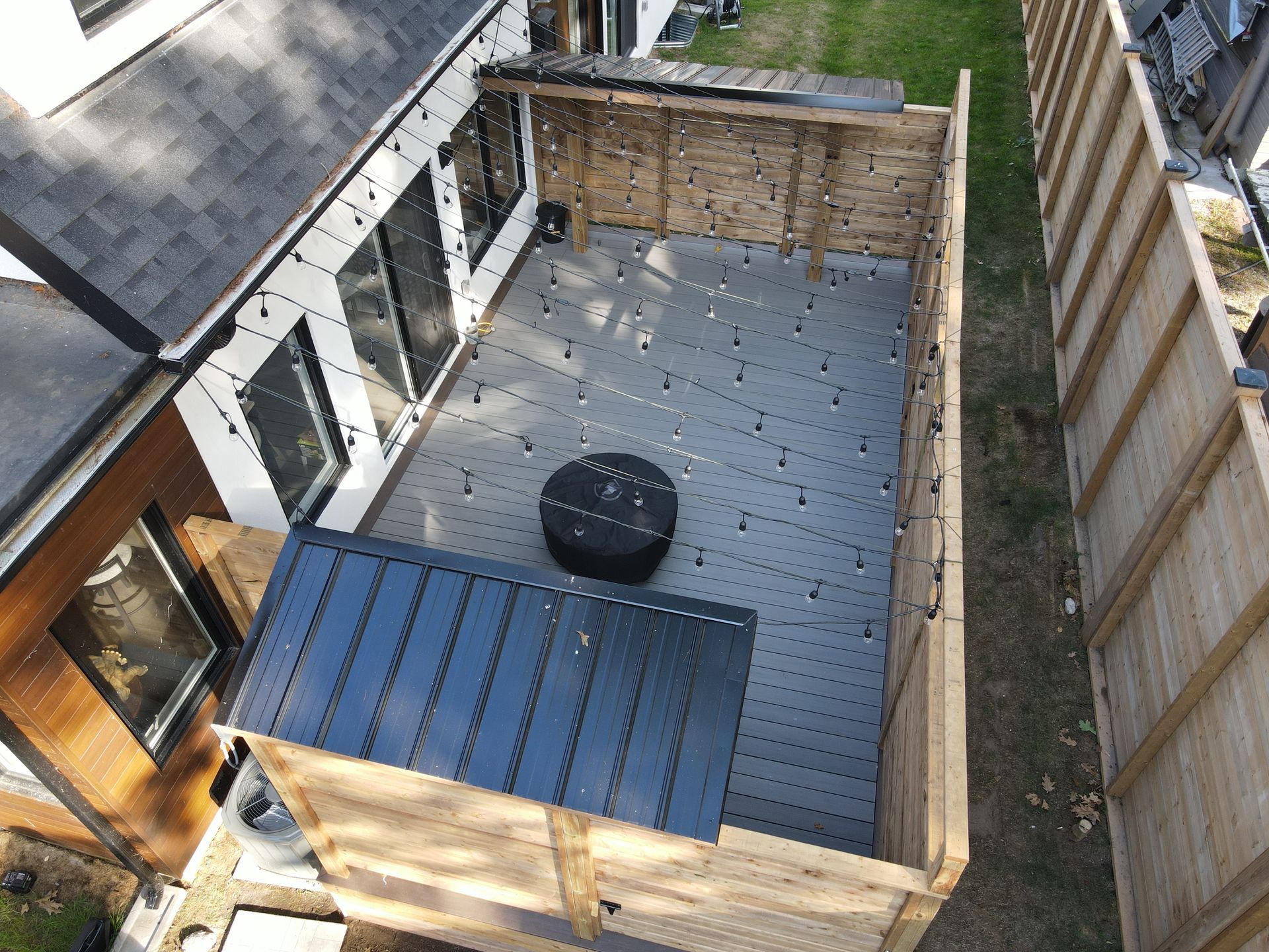Aerial view of a backyard deck with fire pit