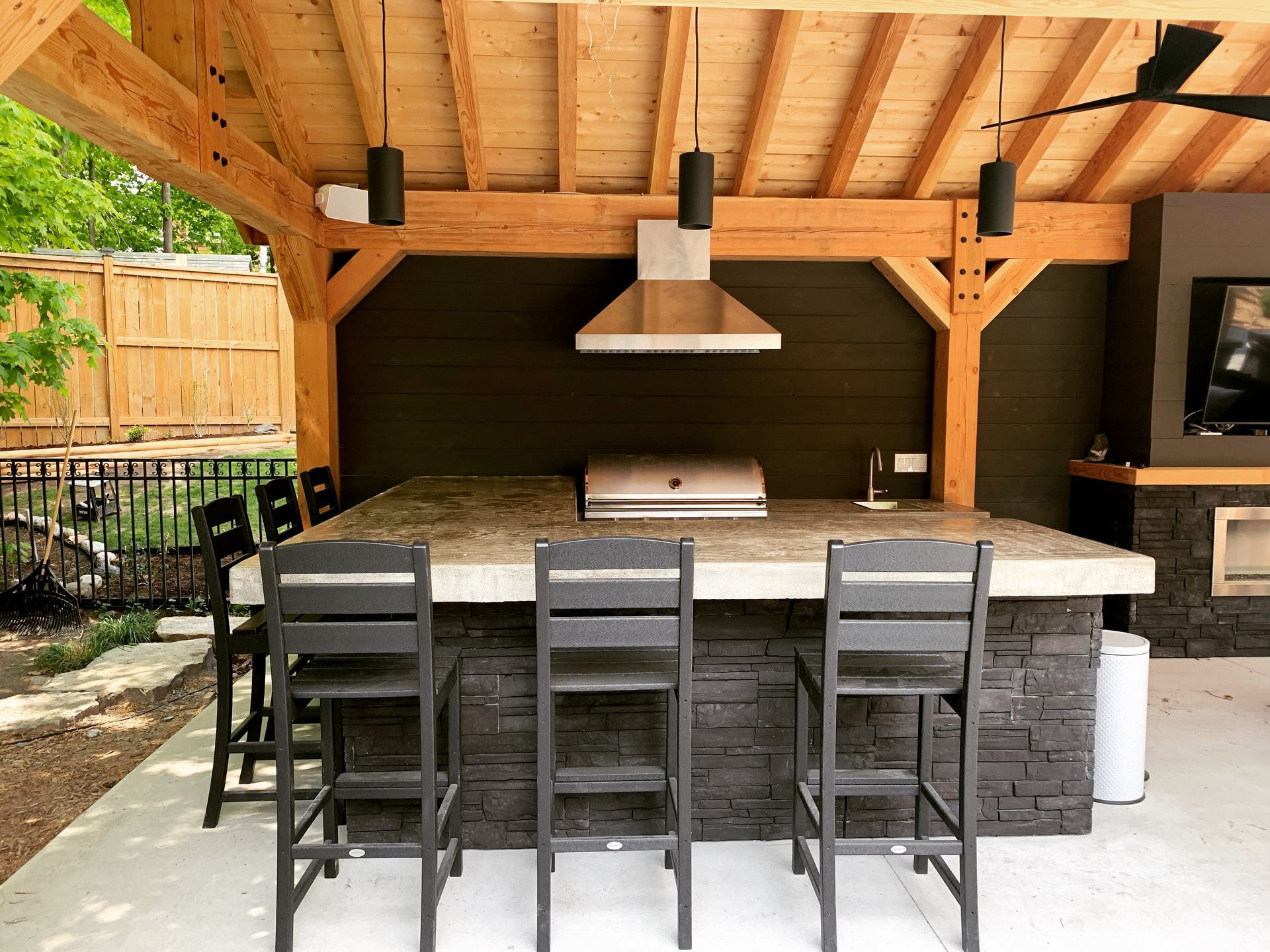 Outdoor kitchen with stone island and granite countertop