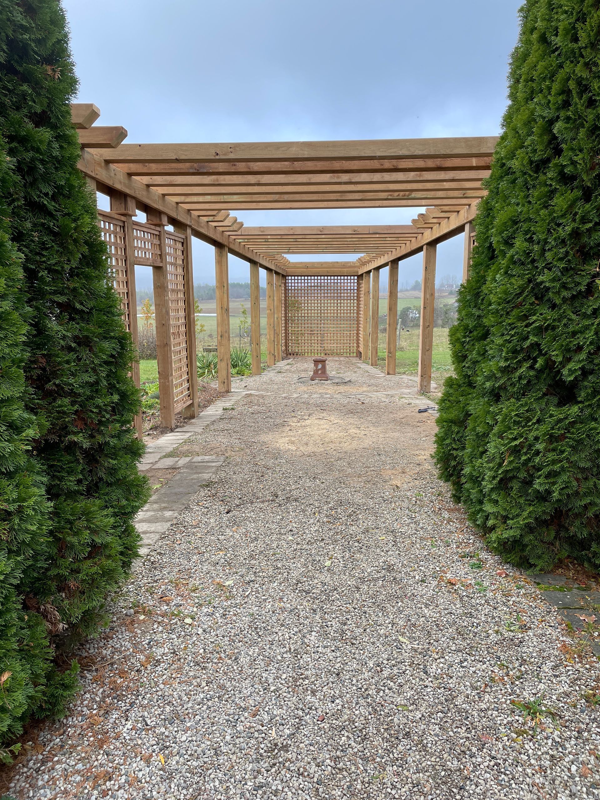 Stone path leading to a wooden pergola