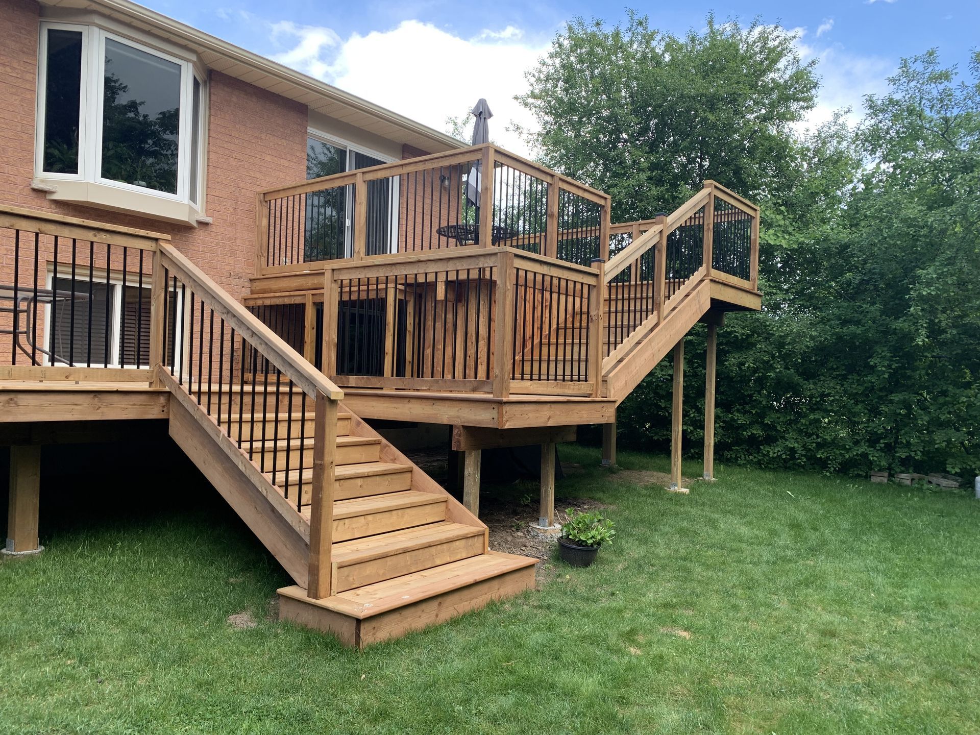 Wooden deck with glass and black metal railing